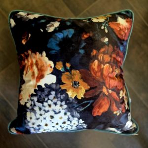 Floral velvet cushion with teal chenille back and piping